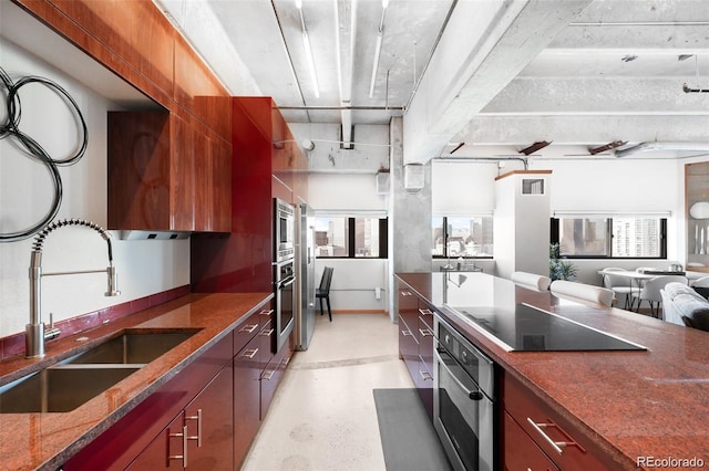 100 Park Ave Unit 2008, Denver, CO 80205 - kitchen featuring appliances with stainless steel finishes, dark stone counters, healthy amount of natural light, and open floor plan