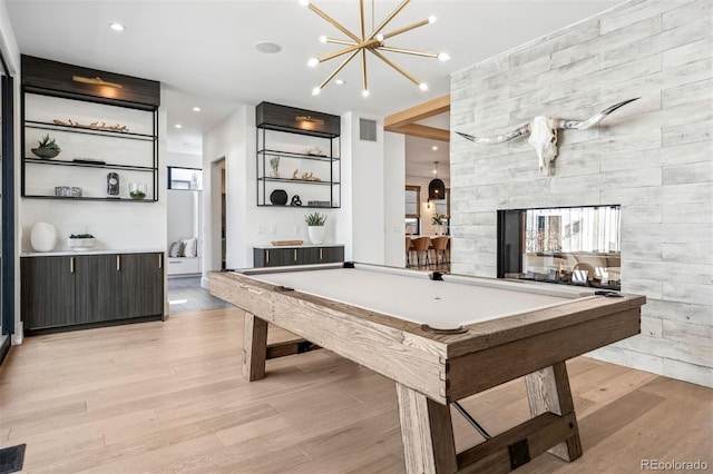 rec room with pool table and light hardwood / wood-style floors