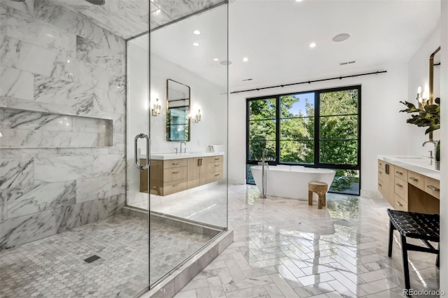 bathroom featuring vanity and shower with separate bathtub