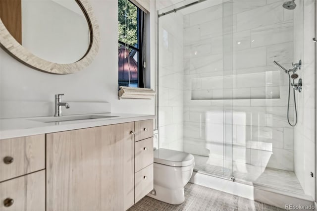 bathroom with vanity, a shower with shower door, and toilet