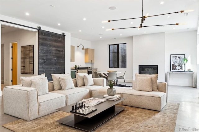 living room with a large fireplace and a barn door