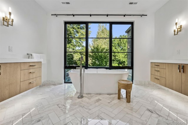 bathroom featuring vanity and a bath