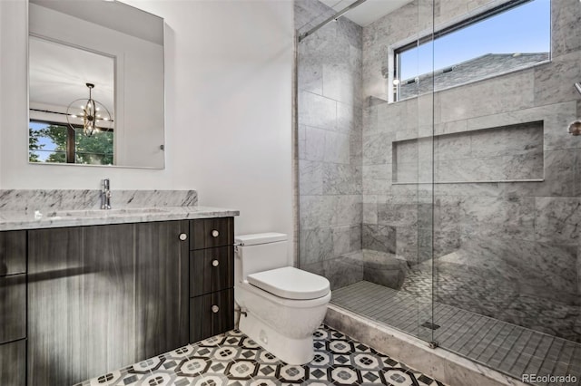 bathroom with toilet, an enclosed shower, an inviting chandelier, vanity, and tile patterned flooring