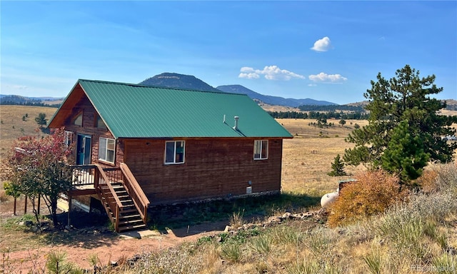 view of home's exterior featuring a deck with mountain view