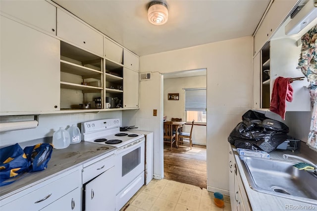 10040 W 13th Pl, Lakewood, CO 80215 - kitchen featuring electric stove, open shelves, light floors, and white cabinetry