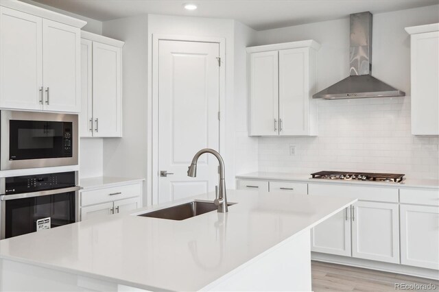 8245 Butte Creek St, Littleton, CO 80125 - kitchen featuring wall chimney range hood, appliances with stainless steel finishes, recessed lighting, a sink, and light countertops