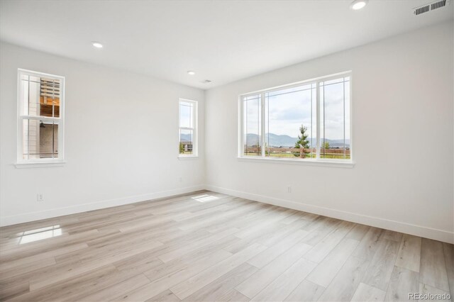 8245 Butte Creek St, Littleton, CO 80125 - unfurnished room featuring baseboards, light wood-style floors, and recessed lighting