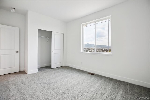 8245 Butte Creek St, Littleton, CO 80125 - unfurnished bedroom with carpet flooring, baseboards, and a closet