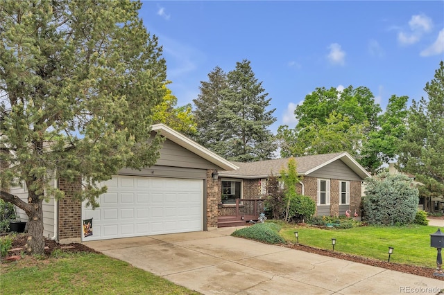 3163 S Boston Ct, Denver, CO 80231 - view of front of property with driveway, a garage, brick siding, and a front yard