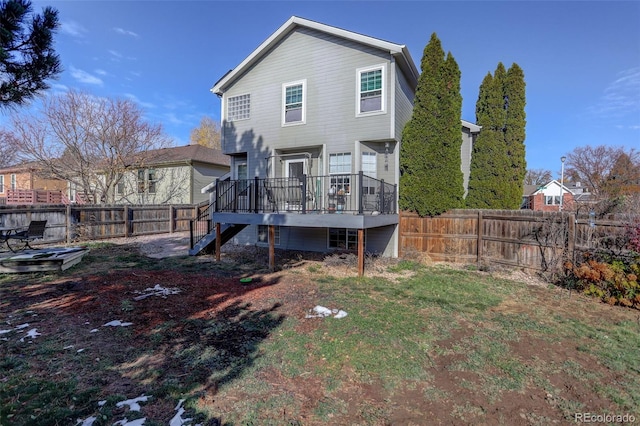 rear view of property featuring a deck