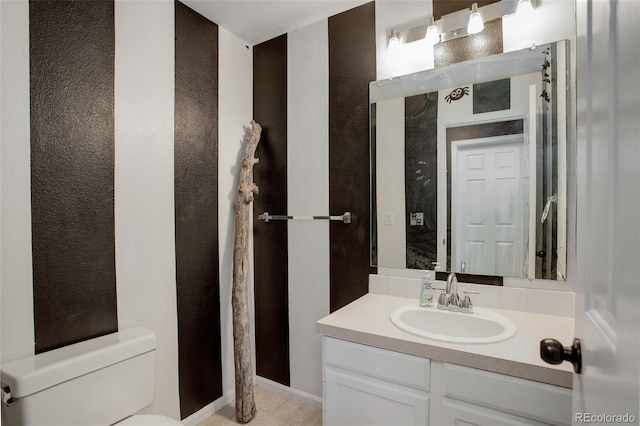 bathroom featuring vanity and toilet