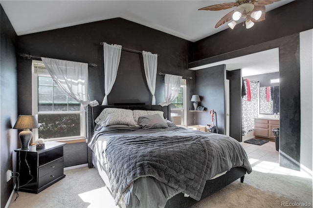 bedroom featuring light carpet, connected bathroom, ceiling fan, and lofted ceiling