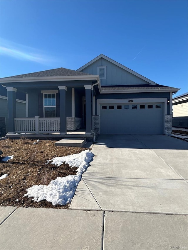 view of front of house with a porch and a garage