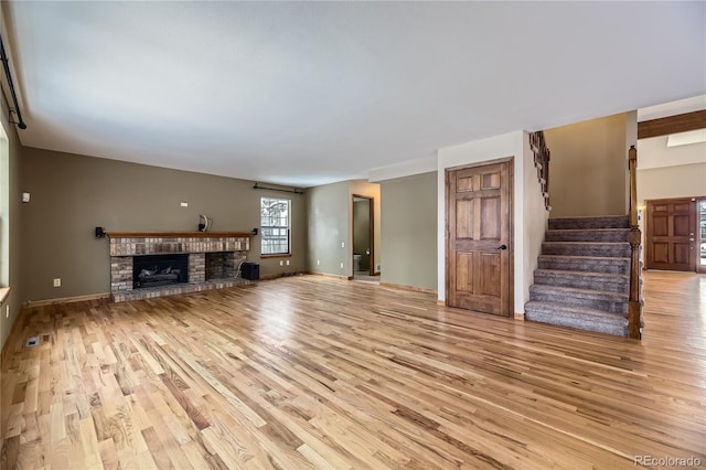 unfurnished living room with light hardwood / wood-style floors and a fireplace