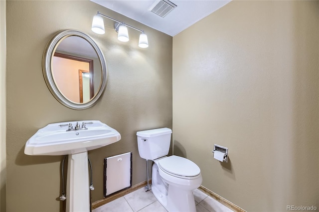 bathroom with tile patterned flooring and toilet