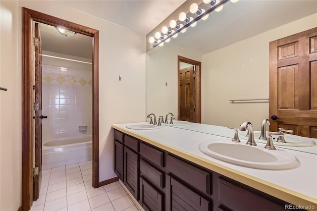 bathroom with tile patterned flooring, vanity, and tiled shower / bath combo