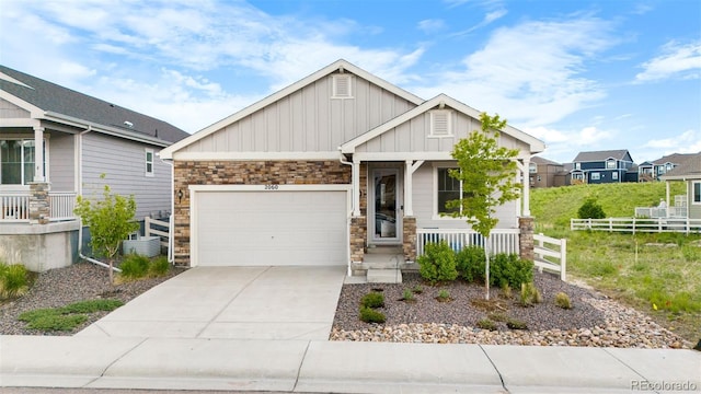 2060 Peralta Loop, Castle Rock, CO 80104 - craftsman-style home featuring board and batten siding, covered porch, stone siding, and a garage