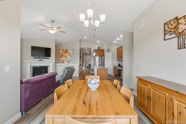 2060 Peralta Loop, Castle Rock, CO 80104 - dining space with a ceiling fan, baseboards, light wood-type flooring, lofted ceiling, and a chandelier