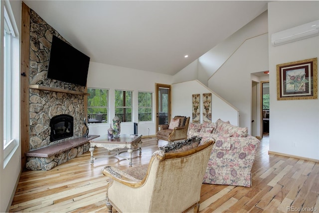 178 Cree Ct, Lyons, CO 80540 - living area featuring a wall unit AC, high vaulted ceiling, wood finished floors, and a fireplace