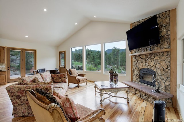 178 Cree Ct, Lyons, CO 80540 - living room featuring a fireplace, high vaulted ceiling, light wood finished floors, french doors, and recessed lighting