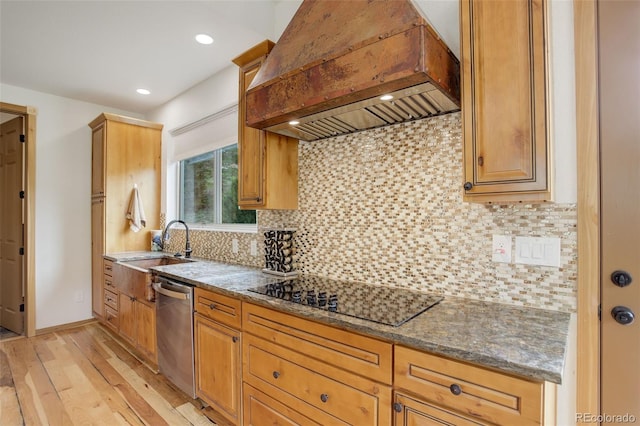 178 Cree Ct, Lyons, CO 80540 - kitchen with premium range hood, black electric stovetop, dishwasher, light wood-style flooring, and dark stone counters