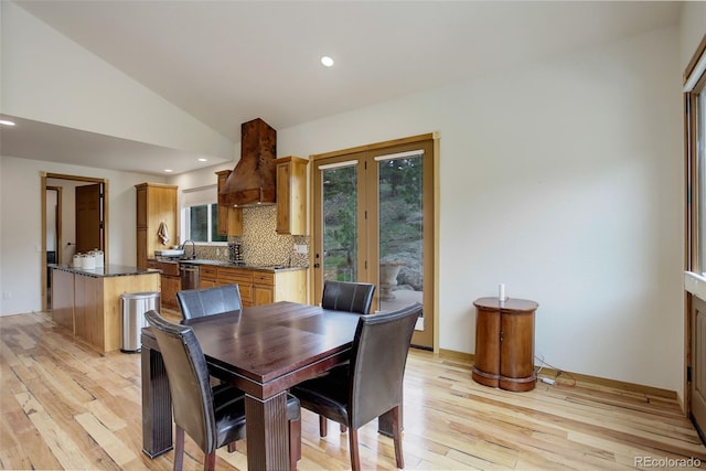 178 Cree Ct, Lyons, CO 80540 - dining space with light wood finished floors, healthy amount of natural light, vaulted ceiling, and recessed lighting