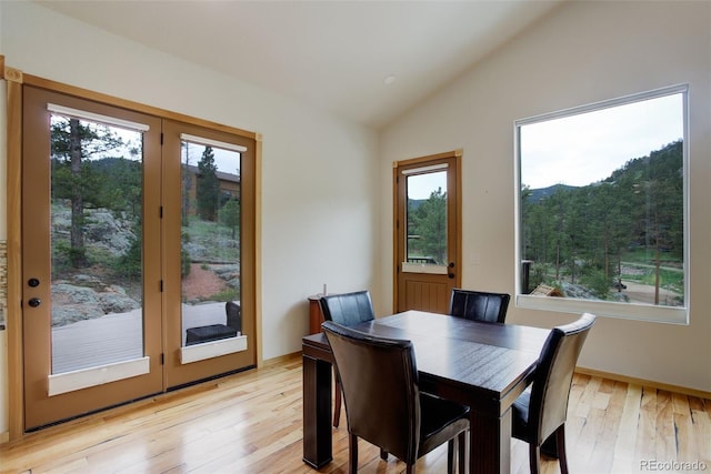 178 Cree Ct, Lyons, CO 80540 - dining area featuring light wood-style flooring and vaulted ceiling