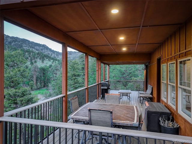 178 Cree Ct, Lyons, CO 80540 - deck featuring outdoor dining area, a mountain view, area for grilling, and a wooded view