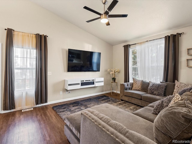 living room with dark wood-type flooring, vaulted ceiling, and ceiling fan