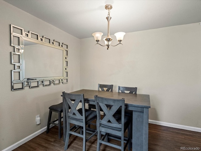 dining room with a notable chandelier and dark hardwood / wood-style floors