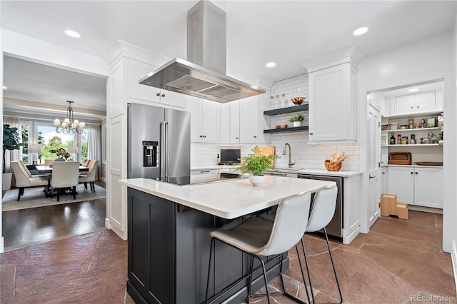 kitchen featuring stainless steel appliances, white cabinetry, a center island, and island range hood