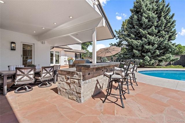 view of patio featuring area for grilling and exterior bar