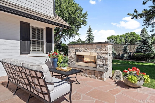 view of patio / terrace featuring an outdoor stone fireplace