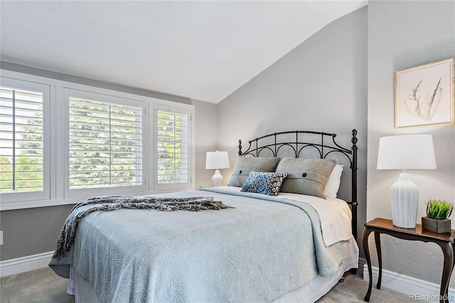 carpeted bedroom with vaulted ceiling