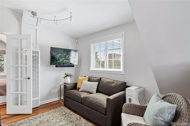 living room featuring vaulted ceiling and hardwood / wood-style floors