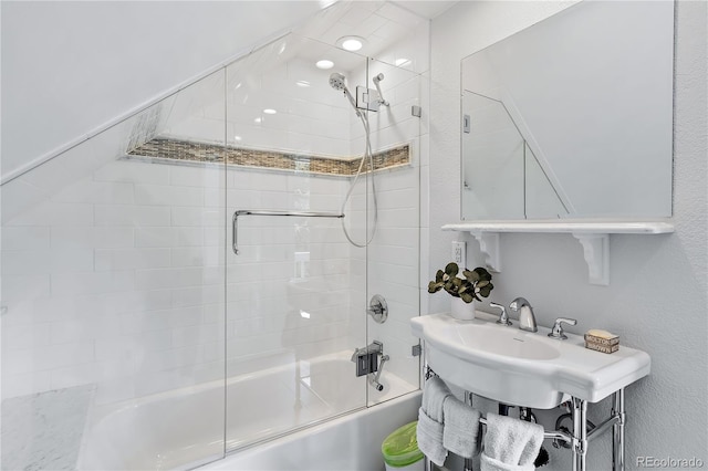 bathroom with bath / shower combo with glass door