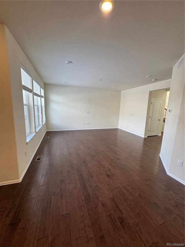 spare room with dark hardwood / wood-style floors