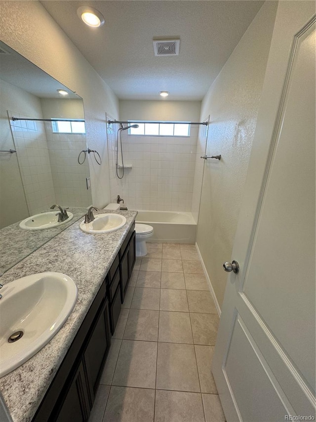 full bathroom with tile patterned flooring, vanity, plenty of natural light, and toilet