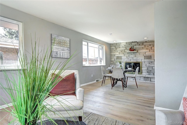 2921 E Colorado Ave, Denver, CO 80210 - sitting room with light wood-style floors, visible vents, a stone fireplace, and baseboards