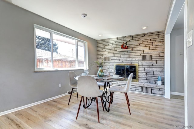 2921 E Colorado Ave, Denver, CO 80210 - dining room with a stone fireplace, baseboards, and wood finished floors