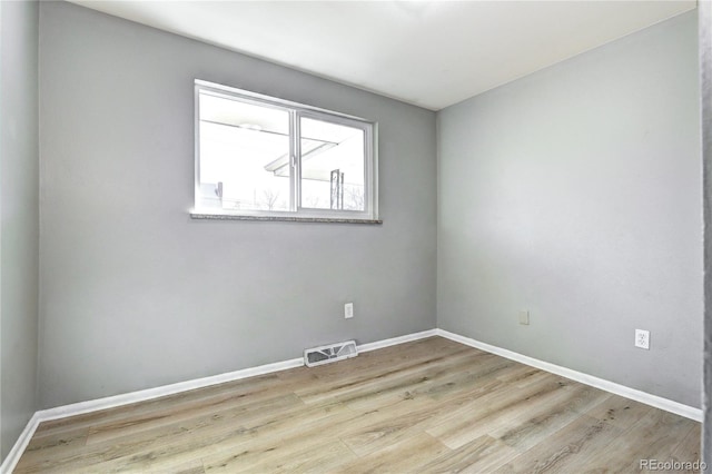 2921 E Colorado Ave, Denver, CO 80210 - spare room with baseboards, visible vents, and wood finished floors