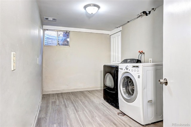 2921 E Colorado Ave, Denver, CO 80210 - laundry room with laundry area, separate washer and dryer, wood finished floors, visible vents, and baseboards