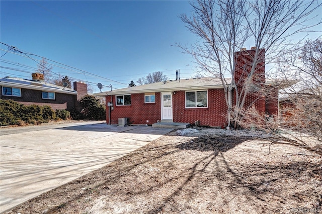 2921 E Colorado Ave, Denver, CO 80210 - ranch-style house with cooling unit, brick siding, and a chimney