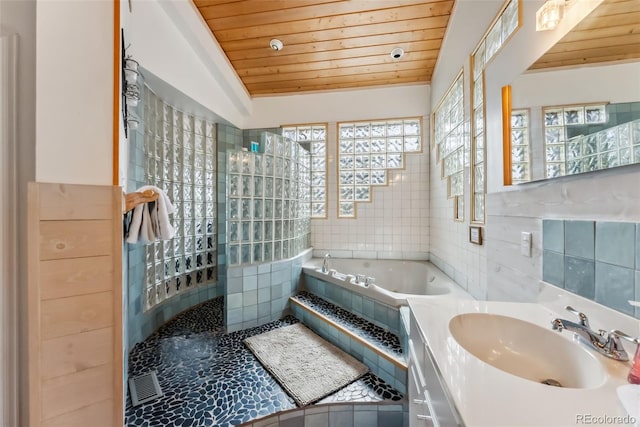 2028 Redhill Rd, Fairplay, CO 80440 - bathroom with wood ceiling, tile walls, a jetted tub, walk in shower, and vanity