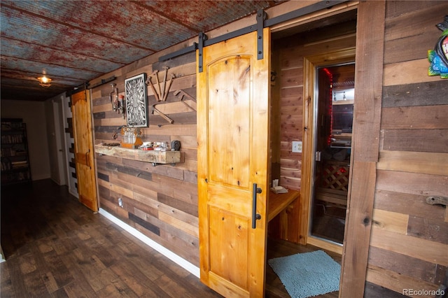 2028 Redhill Rd, Fairplay, CO 80440 - hallway with wood walls, dark wood-type flooring, and a barn door