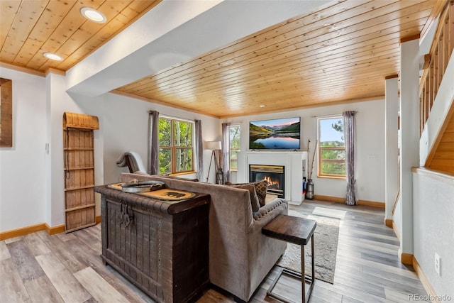 2028 Redhill Rd, Fairplay, CO 80440 - living area with wooden ceiling, stairway, a glass covered fireplace, baseboards, and light wood finished floors