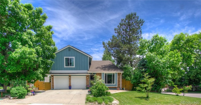8140 S Storm King Peak, Littleton, CO 80127 - view of front of home with an attached garage, concrete driveway, board and batten siding, and brick siding
