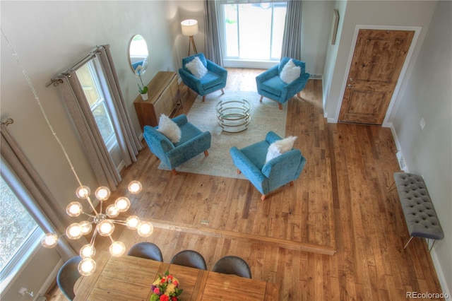 8140 S Storm King Peak, Littleton, CO 80127 - living area featuring wood finished floors and a chandelier