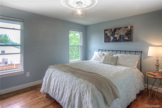8140 S Storm King Peak, Littleton, CO 80127 - bedroom with hardwood / wood-style flooring and baseboards