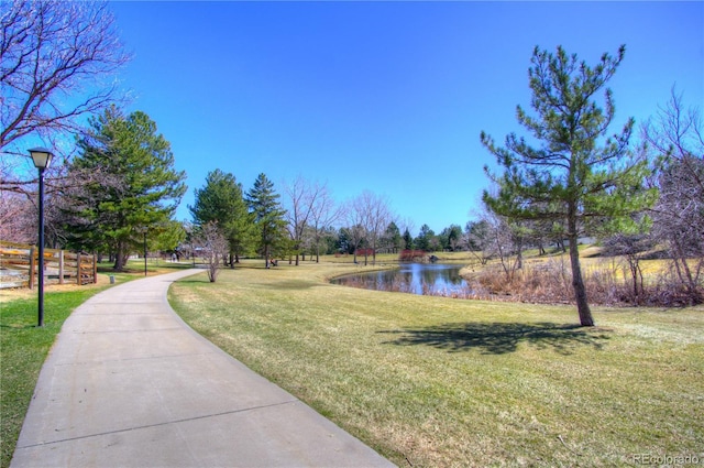 8140 S Storm King Peak, Littleton, CO 80127 - view of home's community with a water view and a lawn